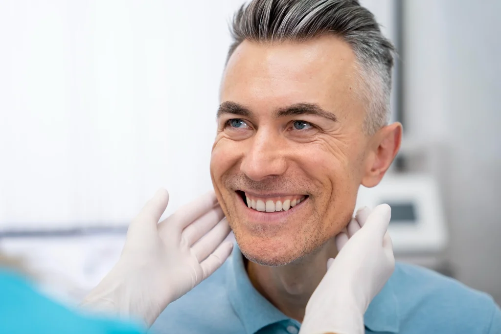 Patient smiling during dental examination after Teeth in a Day dental implant procedure